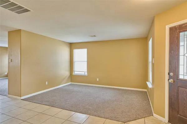 a view of livingroom with an empty space and a window