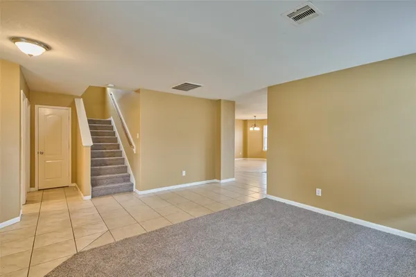 a view of a room with stairs and a ceiling fan