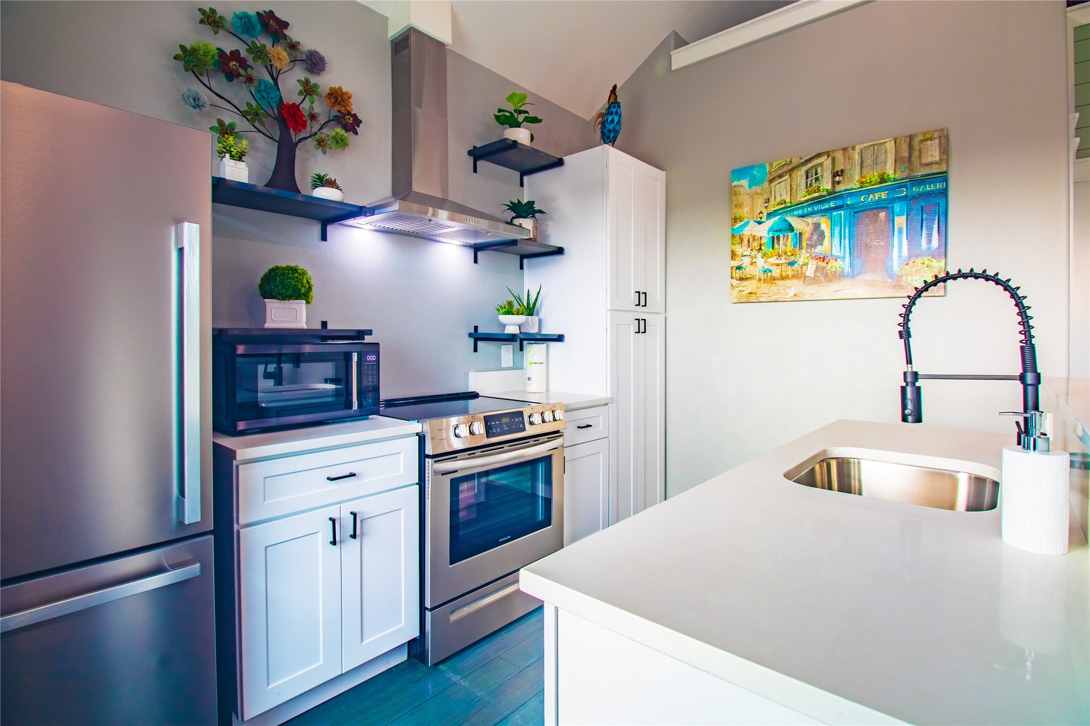 1040 Johnson Road Port Bolivar, TX 77650 - Photo 14 of 49 a kitchen with stainless steel appliances granite countertop a sink and a stove with wooden floor