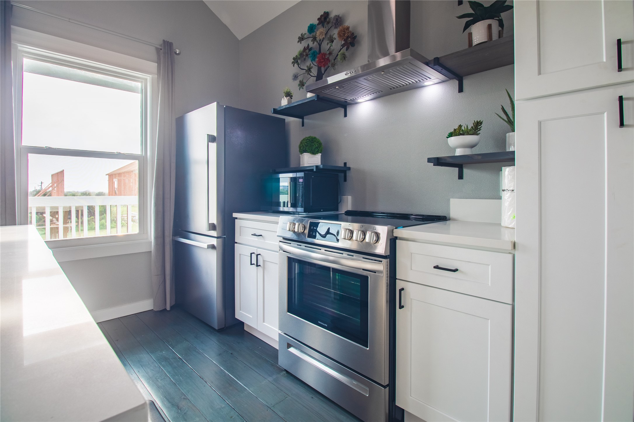 1040 Johnson Road Port Bolivar, TX 77650 - Photo 19 of 49 a kitchen with stainless steel appliances a stove a refrigerator and a window