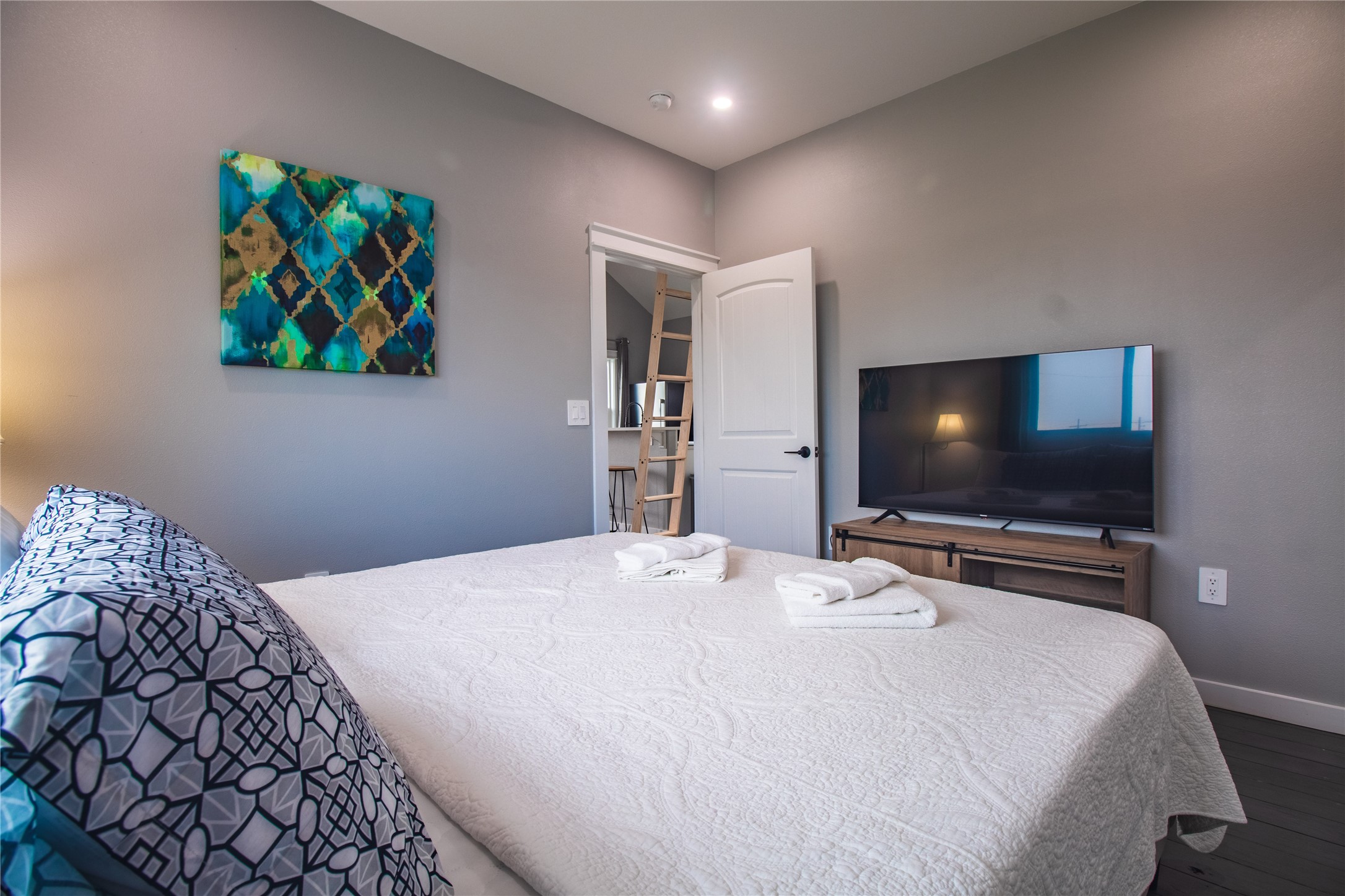 1040 Johnson Road Port Bolivar, TX 77650 - Photo 24 of 49 a bedroom with a bed and a flat screen tv