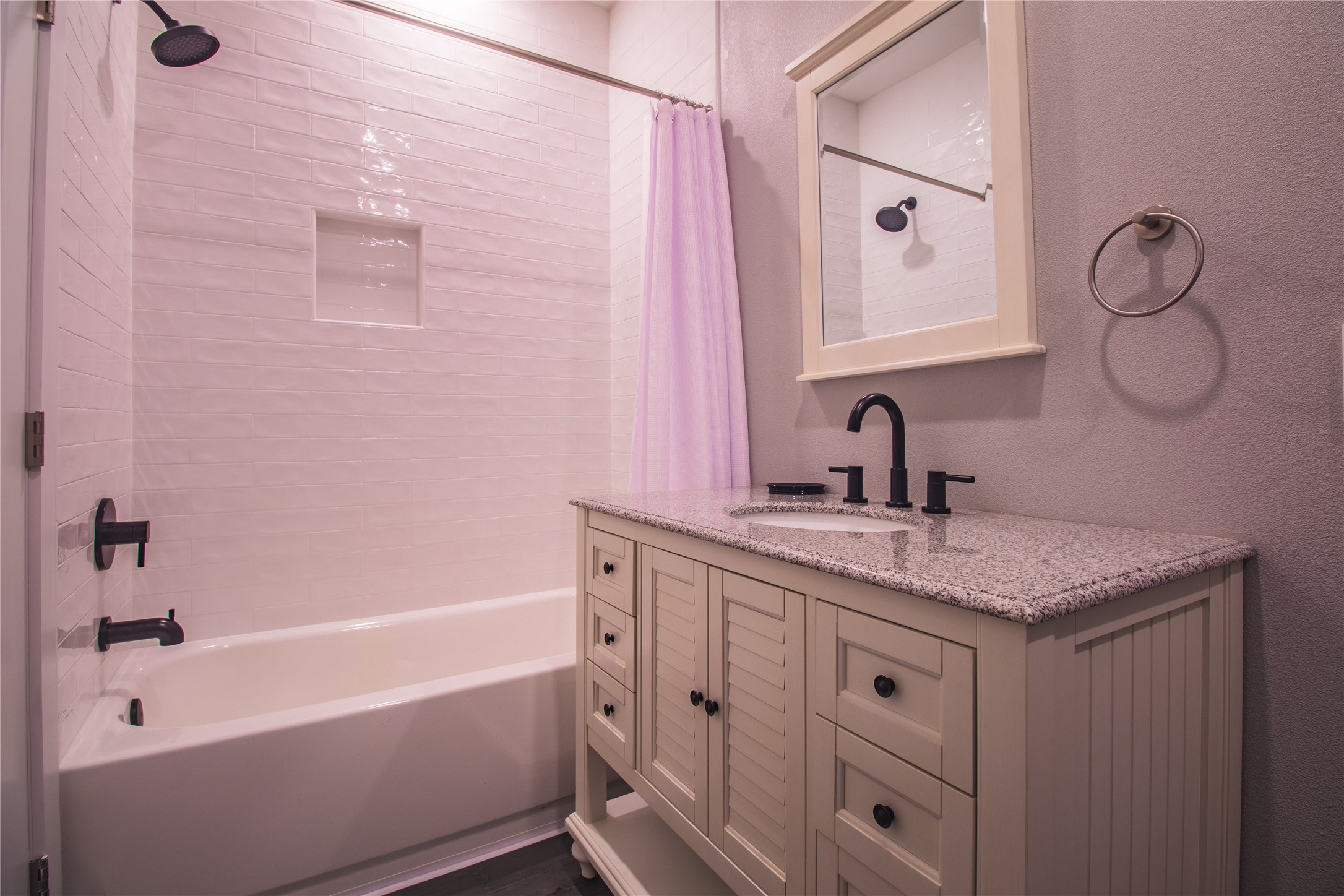 1040 Johnson Road Port Bolivar, TX 77650 - Photo 26 of 49 a bathroom with a granite countertop sink a toilet and bathtub