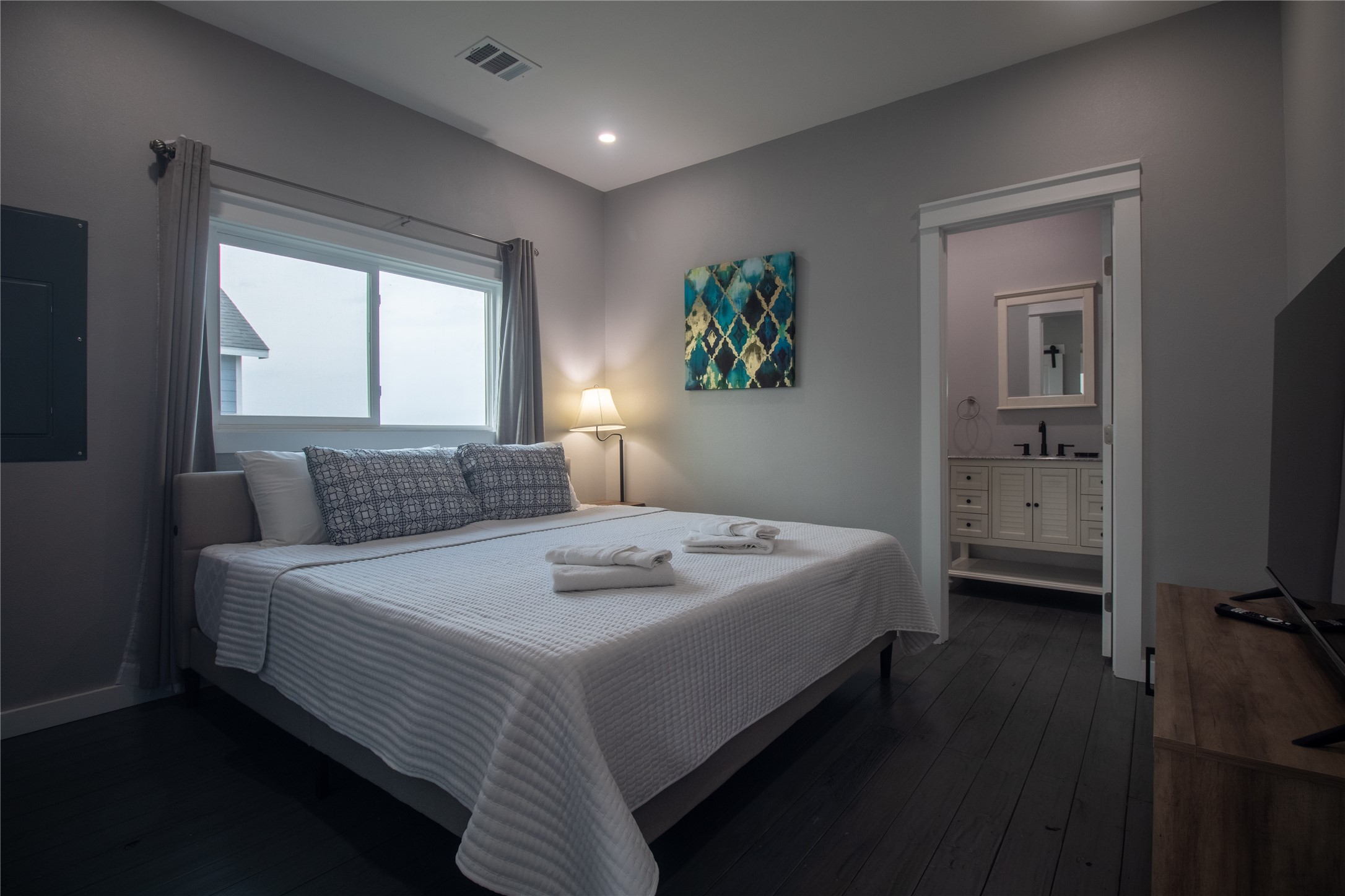 1040 Johnson Road Port Bolivar, TX 77650 - Photo 28 of 49 a bedroom with a bed and a flat tv screen on dresser