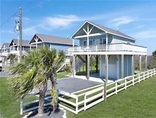 1040 Johnson Road Port Bolivar, TX 77650 - Photo 3 of 49 a front view of a house with a yard balcony and outdoor seating