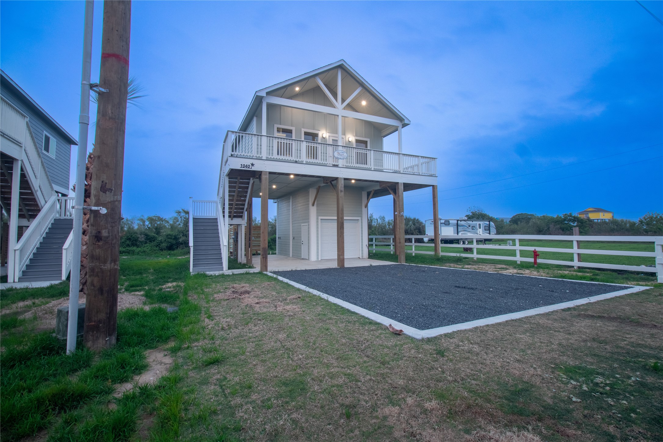 1040 Johnson Road Port Bolivar, TX 77650 - Photo 6 of 49 a front view of a house with a yard and garage