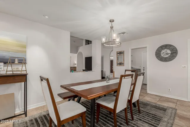 a view of a dining room with furniture and a chandelier