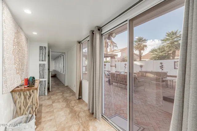 a bathroom with a glass shower door and a window