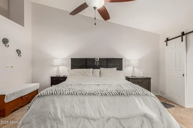 a bedroom with a bed and lamp