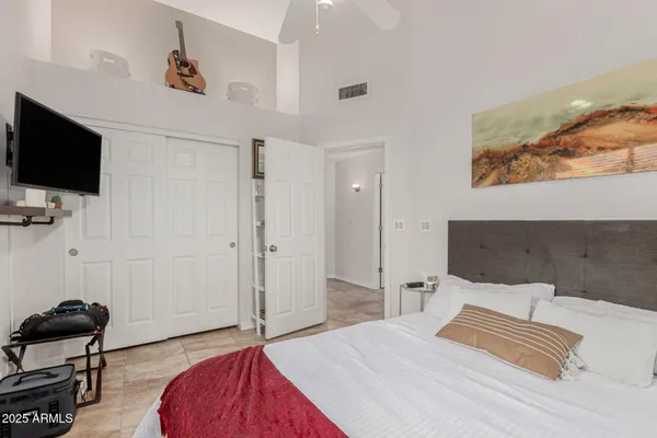 a bedroom with a bed and a flat screen tv