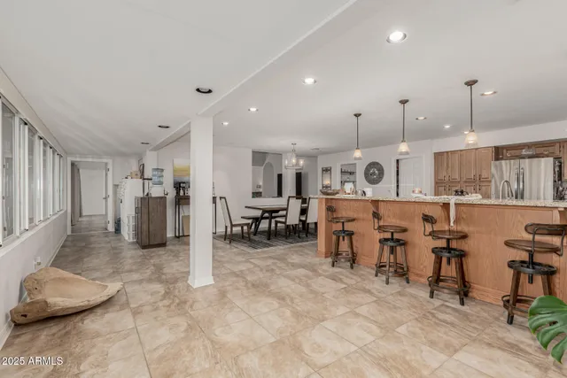 a large kitchen with lots of furniture and chairs