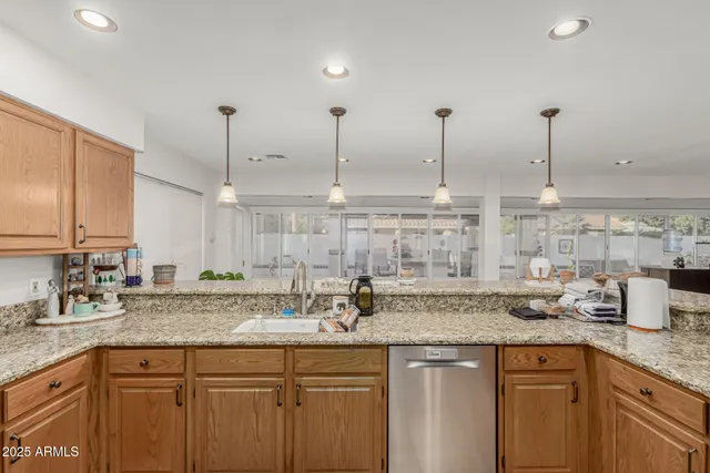 a kitchen with sink stove and cabinets