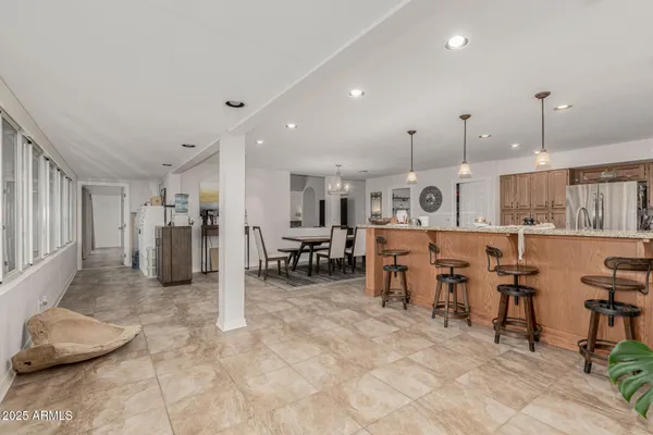 a large kitchen with lots of furniture and chairs