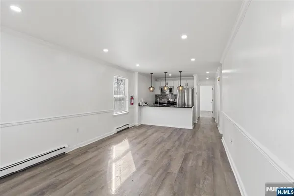 a view of kitchen with refrigerator and window