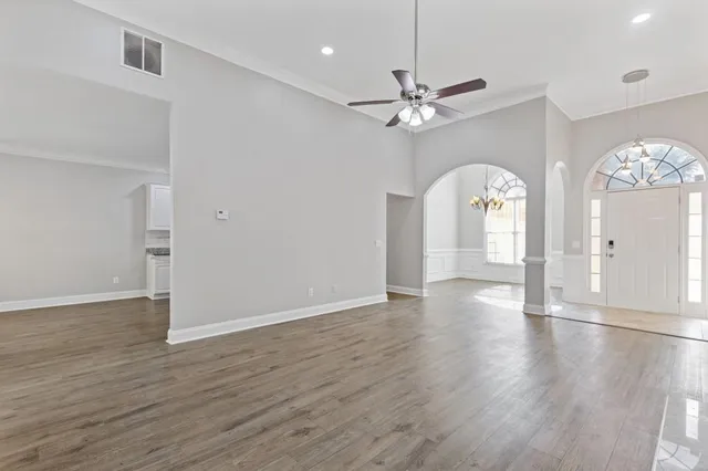 wooden floor in an empty room with a window