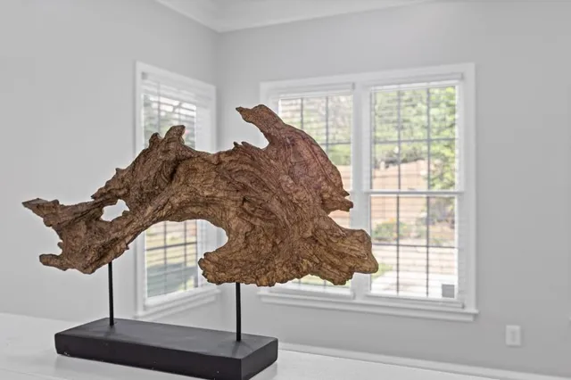 a room with a large window and chandelier