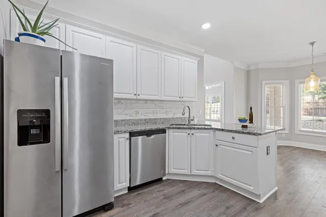 a bathroom with a granite countertop double vanity sink and a mirror