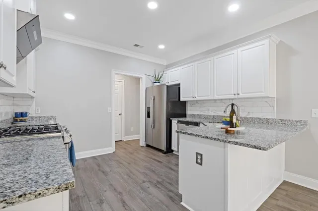 a bathroom with a granite countertop double vanity sinks and a mirror