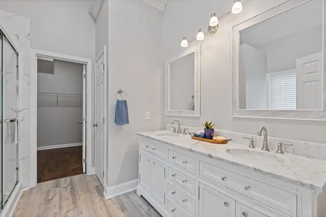a view of staircase with wooden floor and white walls