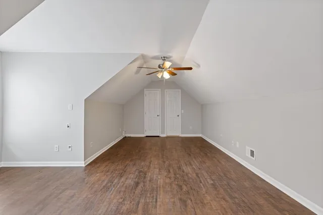 a living room with patio furniture and a garden