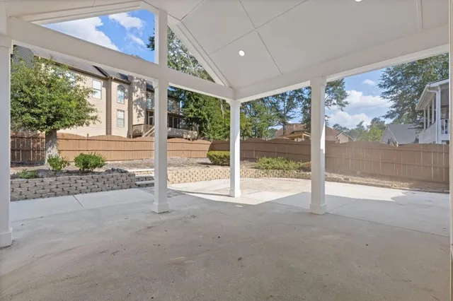 an aerial view of residential house with outdoor space and trees