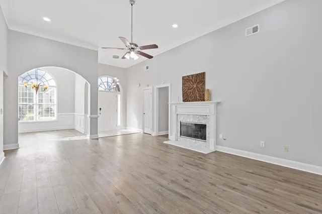 an empty room with wooden floor a ceiling fan and closet