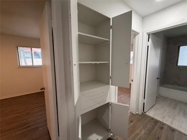 a view of a hallway with wooden floor