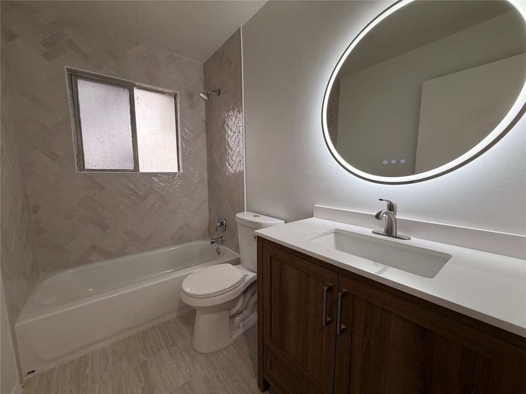 2308 Alta Vista Avenue, Unit B Austin, TX 78704 - Photo 15 of 23 a bathroom with a sink a toilet and a mirror