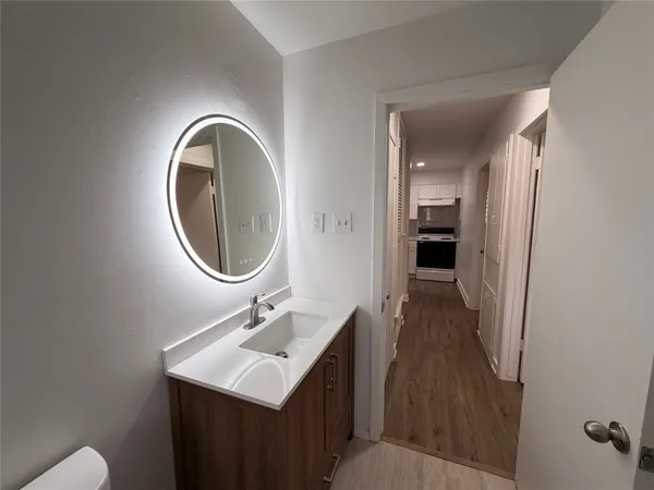 a bathroom with a sink a toilet and a mirror