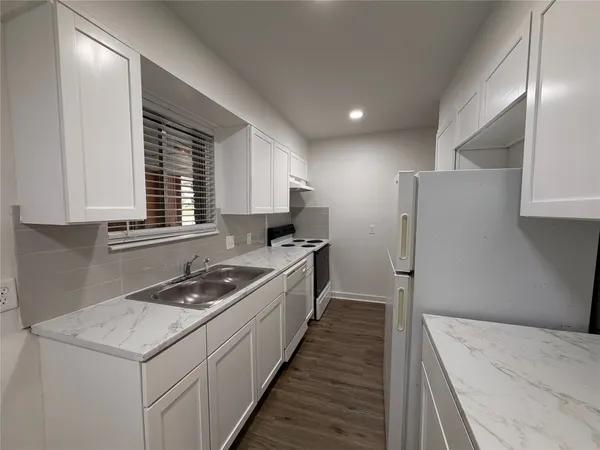 a kitchen with a table and chairs in it