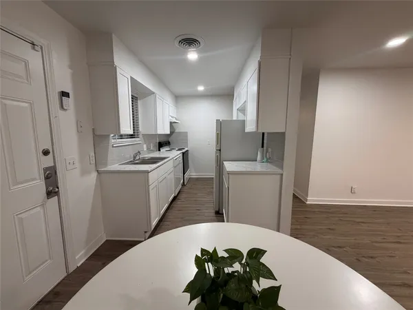 a kitchen with a sink stove and refrigerator