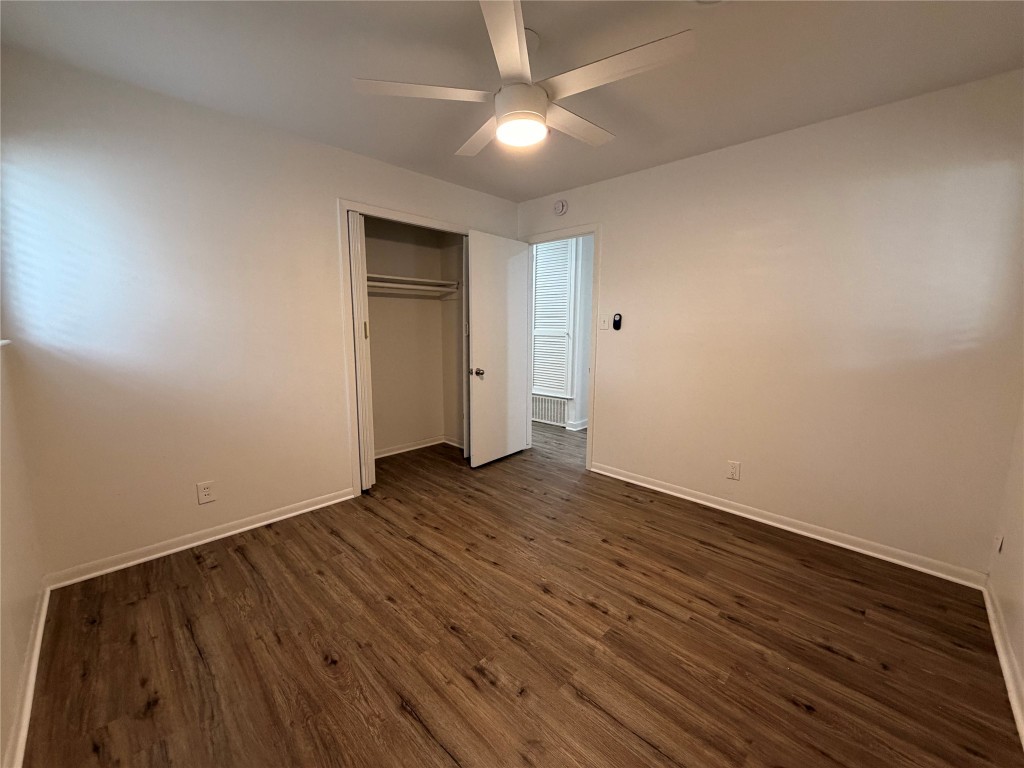 2308 Alta Vista Avenue, Unit B Austin, TX 78704 - Photo 9 of 23 a view of an empty room with wooden floor and a ceiling fan