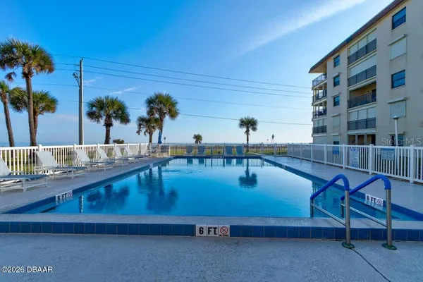 a swimming pool with outdoor seating