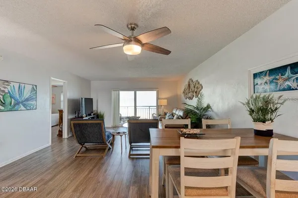 a view of a dining room with furniture window and wooden floor