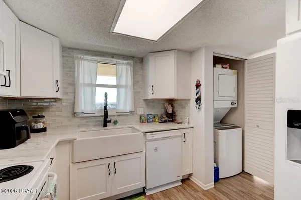 a kitchen with a sink a stove and cabinets