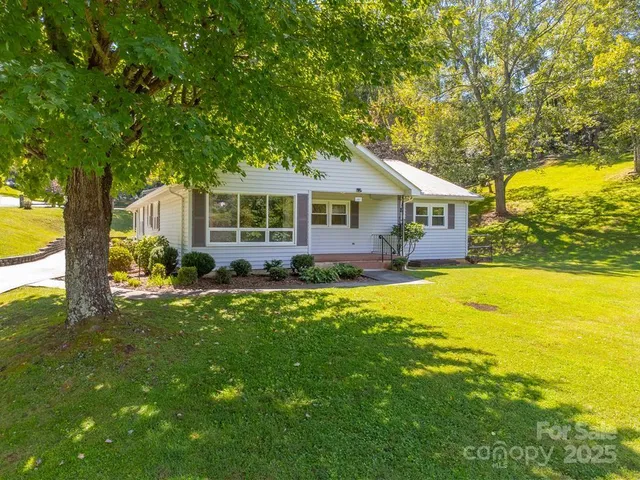 a house view with swimming pool and garden space