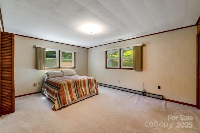 a bedroom with a bed and window