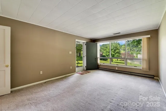 a view of an empty room with a window