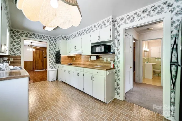 a kitchen with granite countertop a sink and refrigerator
