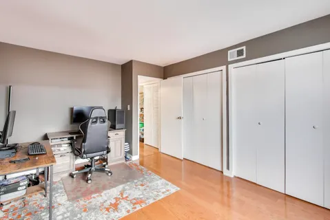 a view of a workspace with furniture and a window