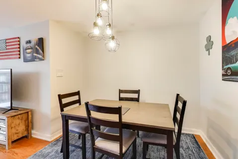 a view of a dining room with furniture and wooden floor