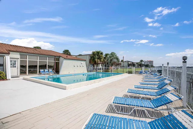 a view of a house with wooden floor and a yard