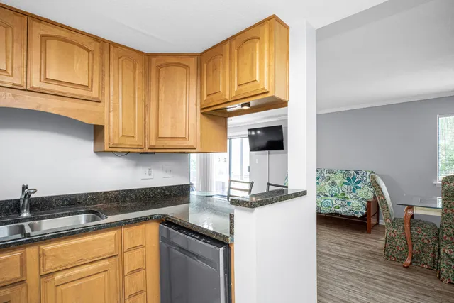 a kitchen with stainless steel appliances granite countertop a refrigerator sink and cabinets