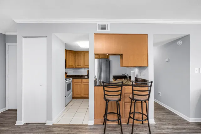 a living room with furniture a dining table and a chandelier