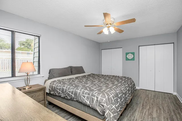 a bedroom with a bed and a flat tv screen on the dresser