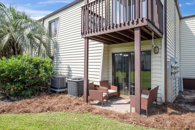 a view of a chair and fire pit in backyard of the house