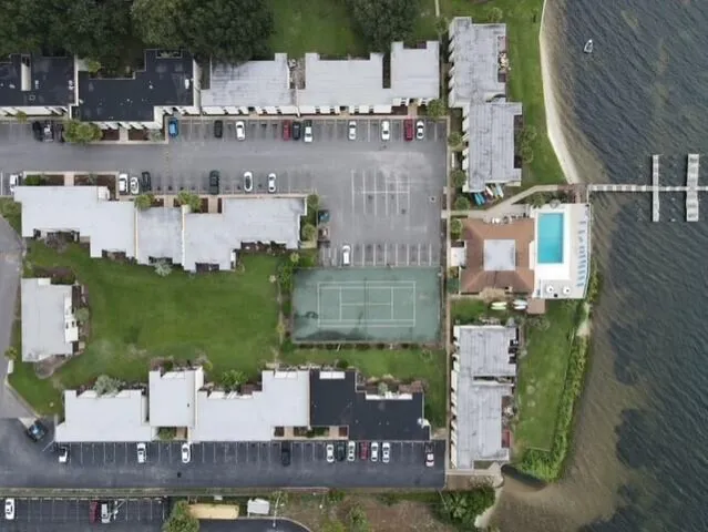 an aerial view of residential houses with outdoor space and parking
