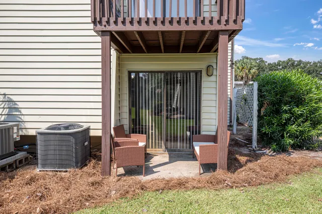 a view of a chair and table in the patio