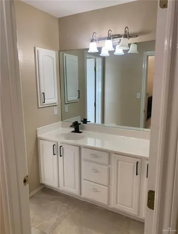a bathroom with a double vanity sink and a mirror