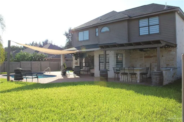 a view of a house with a yard and sitting area