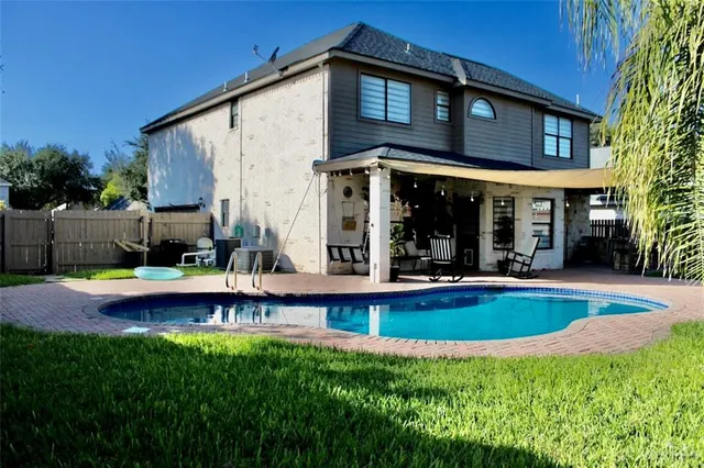 a view of a house with pool yard and swimming pool